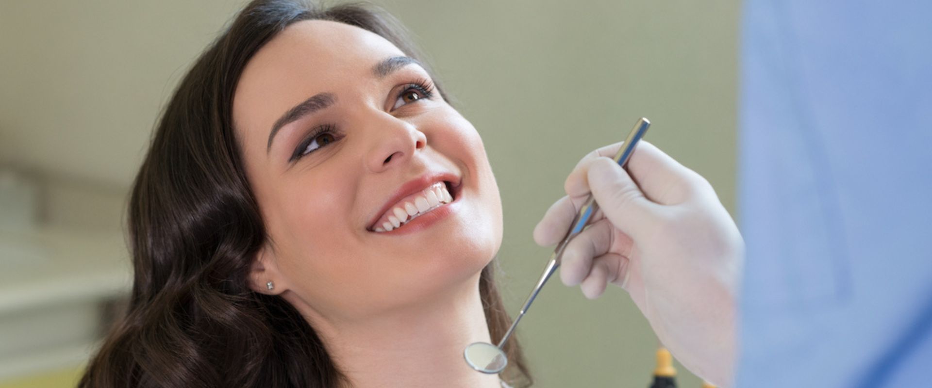 woman smiles at orthodontist at her first orthodontist appointment