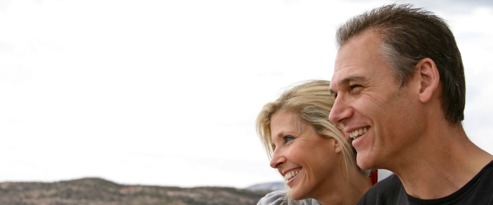 couple stares out over valley and debates veneers vs Invisalign