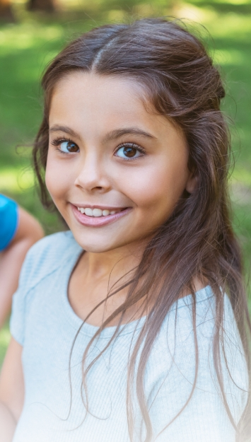 Child smiling during orthodontic consultation for braces or aligners